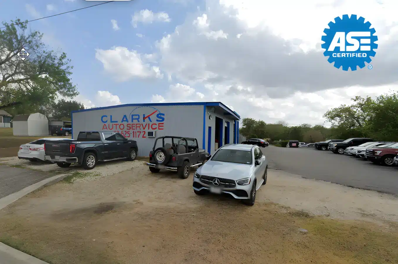 Auto repair in New Braunfels, TX by Clark’s Auto Service. Image of ASE-certified auto repair shop exterior with multiple vehicles, highlighting trusted service, professional diagnostics, and reliable maintenance for all makes and models.