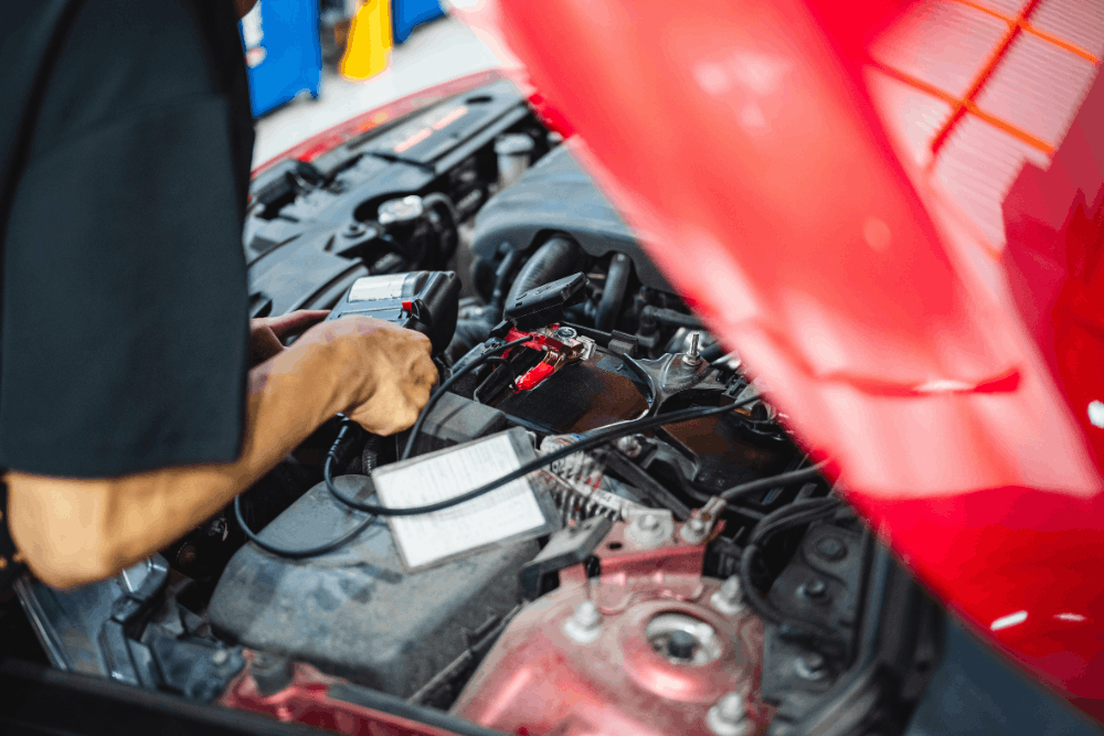 National Car Care Month, auto repair in New Braunfels, TX, at Clark’s Auto Service. Image of technician using a battery tester on a vehicle, highlighting reliable starting power and electrical system performance.